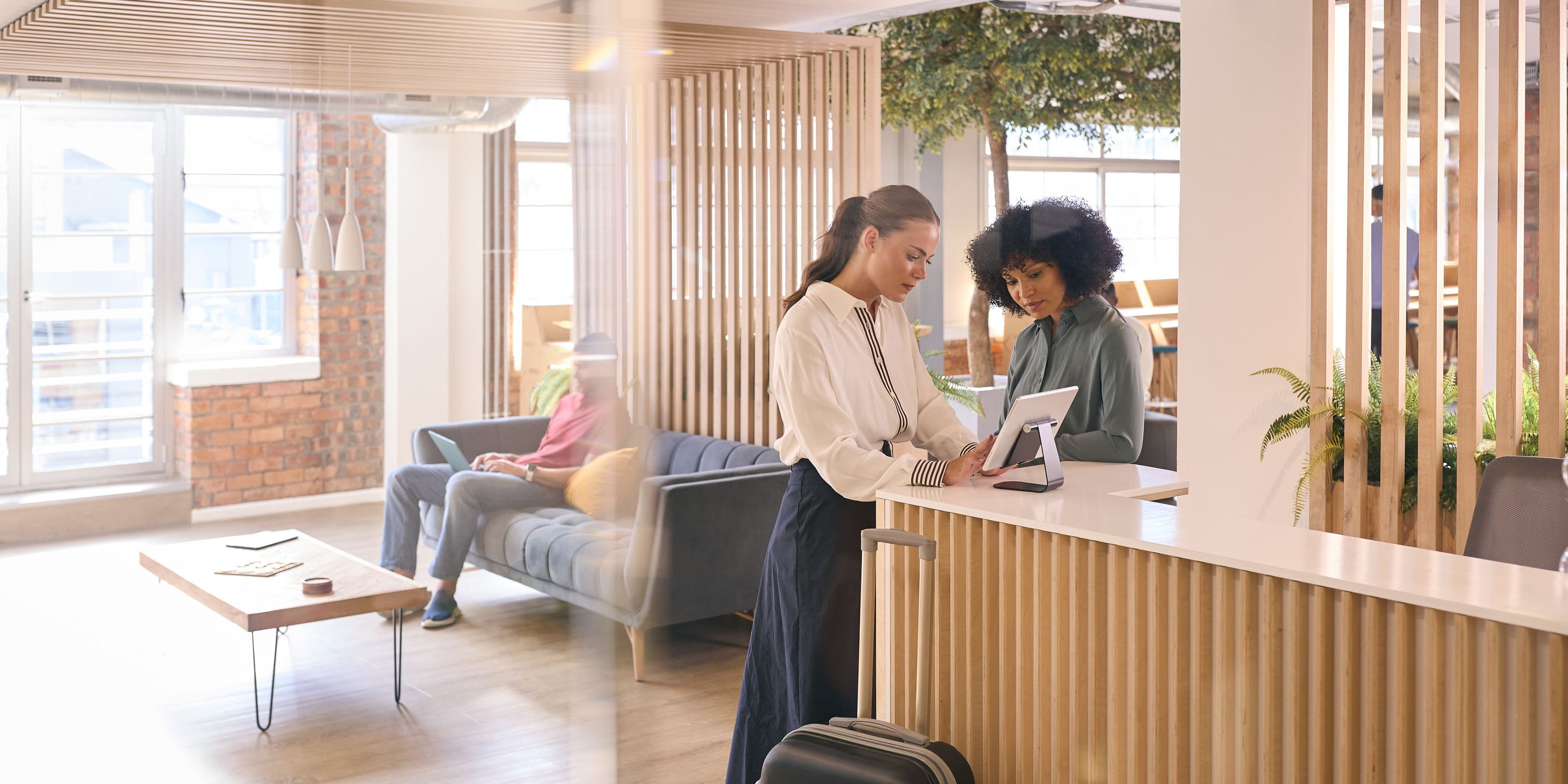Hotel staff member warmly greeting a guest